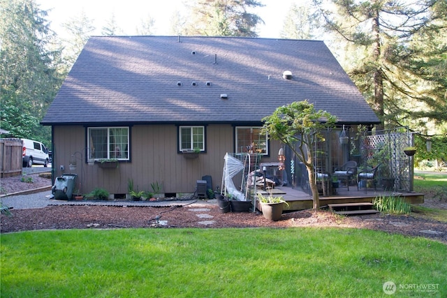 rear view of property featuring a wooden deck, a shingled roof, a yard, and crawl space