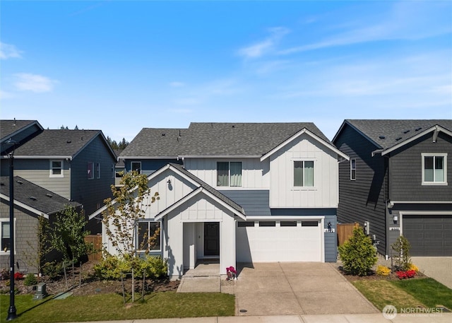 view of front of home with board and batten siding, concrete driveway, a garage, and a shingled roof