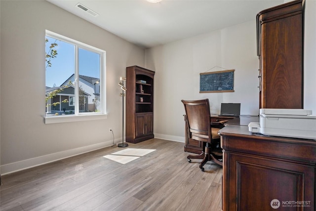 home office featuring light wood-type flooring and baseboards