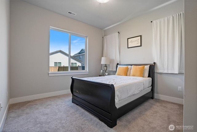 carpeted bedroom featuring baseboards