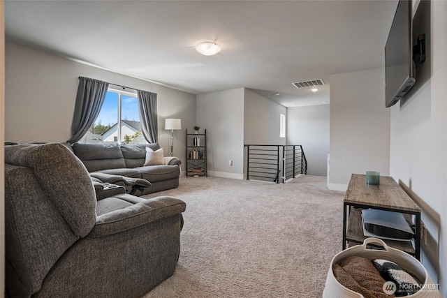 carpeted living area featuring baseboards and recessed lighting