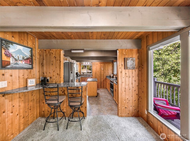 1418 E Blackburn Rd, Mount Vernon, WA 98274 - kitchen with wooden walls, a peninsula, stainless steel refrigerator with ice dispenser, wood ceiling, and brown cabinetry