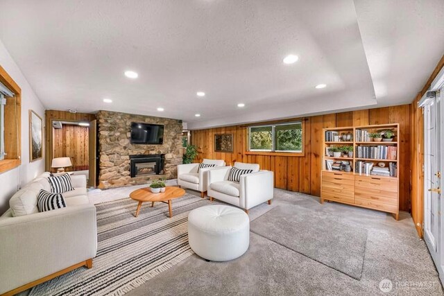 1418 E Blackburn Rd, Mount Vernon, WA 98274 - carpeted living room with wooden walls, a stone fireplace, and recessed lighting