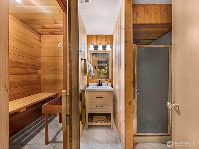 1418 E Blackburn Rd, Mount Vernon, WA 98274 - full bath featuring a shower stall, wood walls, marble finish floors, and vanity