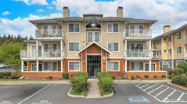 564 225th Ln NE Unit A-105, Sammamish, WA 98074 - view of building exterior with uncovered parking