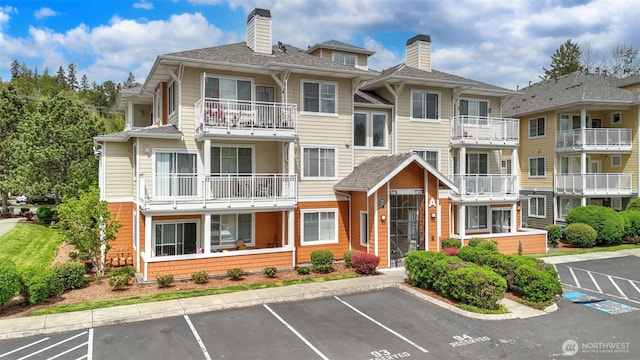 564 225th Ln NE Unit A-105, Sammamish, WA 98074 - view of building exterior featuring uncovered parking