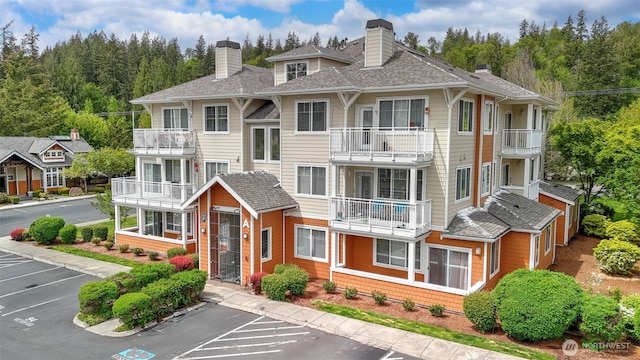 564 225th Ln NE Unit A-105, Sammamish, WA 98074 - view of property featuring uncovered parking