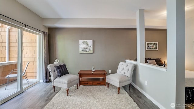 564 225th Ln NE Unit A-105, Sammamish, WA 98074 - living area featuring wood finished floors, healthy amount of natural light, and baseboards