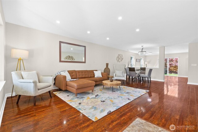 living area with hardwood / wood-style floors, baseboards, recessed lighting, and a chandelier