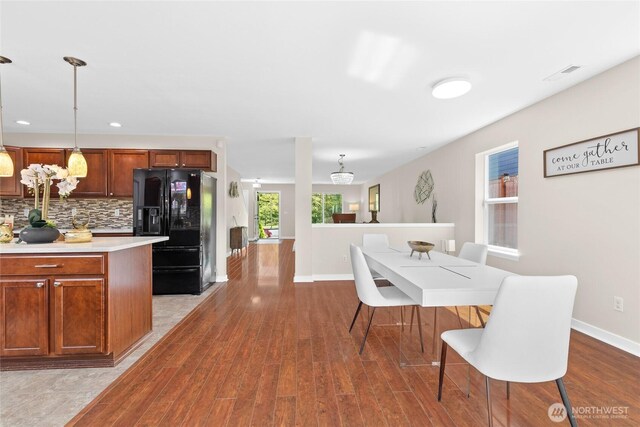 dining space featuring wood finished floors, baseboards, and recessed lighting