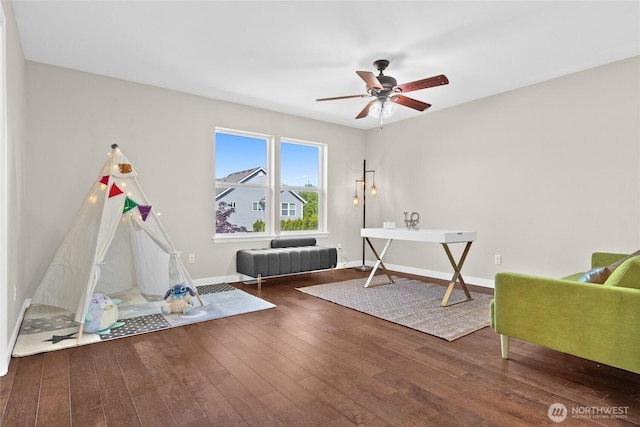 playroom featuring ceiling fan, wood finished floors, and baseboards