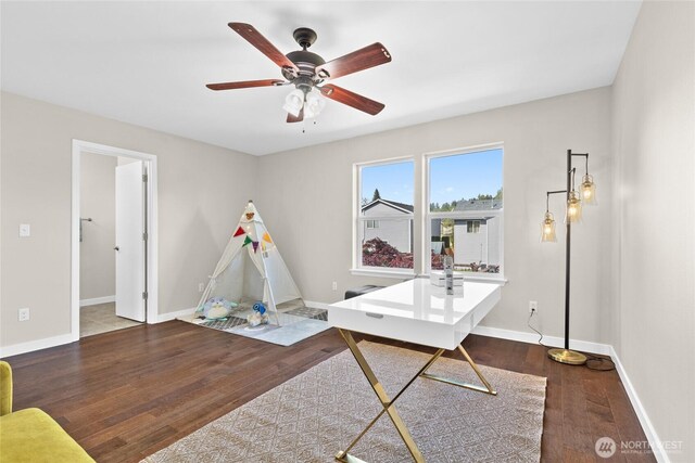 office area featuring wood finished floors, ceiling fan, and baseboards