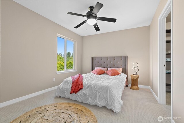 carpeted bedroom featuring baseboards and ceiling fan