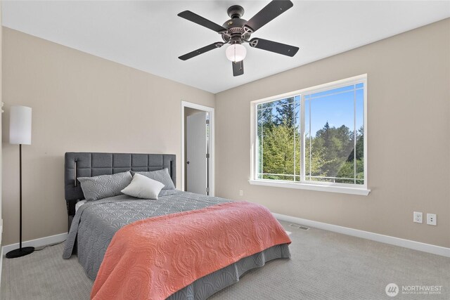 carpeted bedroom featuring baseboards and a ceiling fan