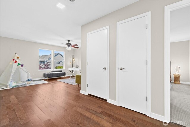 interior space with wood finished floors and baseboards