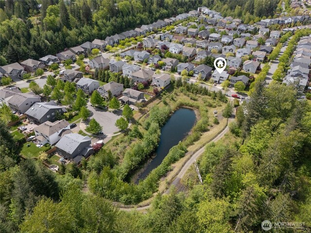 aerial overview of property's location featuring nearby suburban area and a nearby body of water