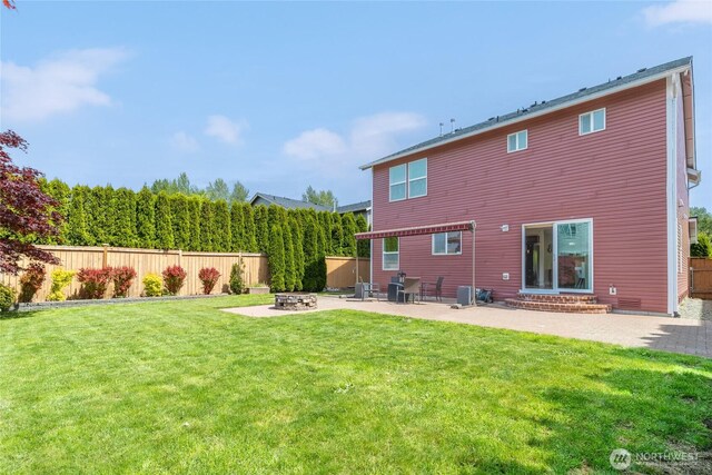 back of house with a patio and a fire pit