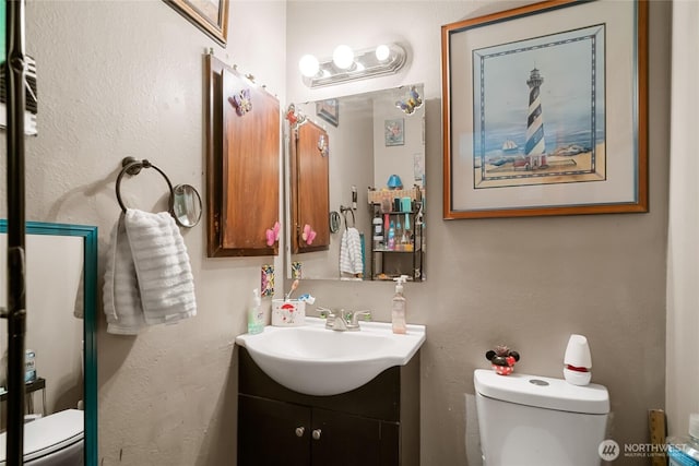 bathroom with toilet and vanity