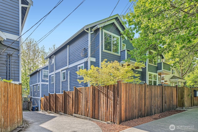 view of home's exterior with fence