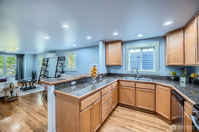 kitchen with tile counters, a sink, recessed lighting, stainless steel dishwasher, and a peninsula