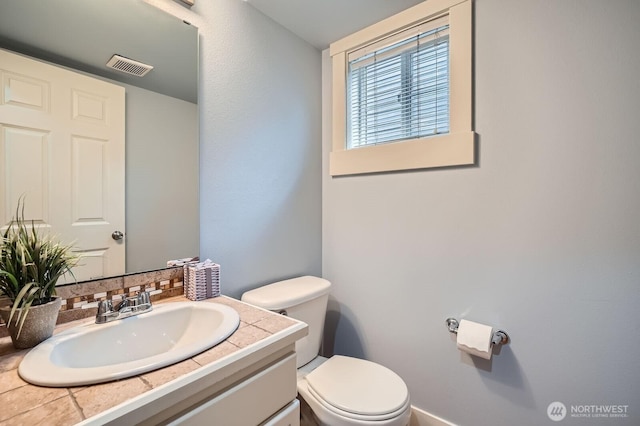 bathroom featuring toilet and vanity