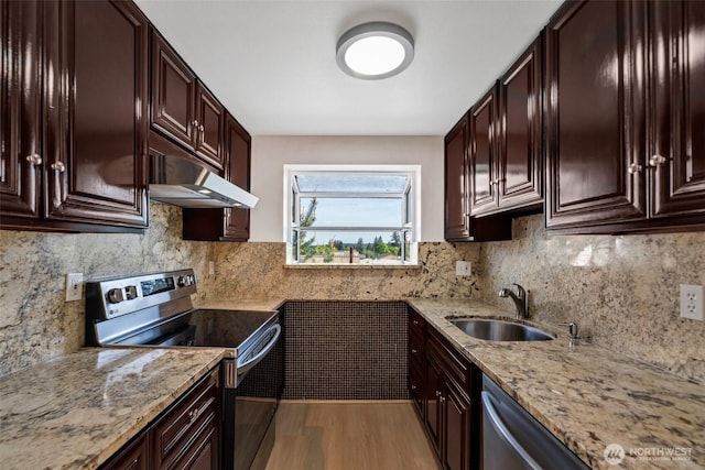12050 15th Ave NE Unit 404, Seattle, WA 98125 - kitchen featuring stainless steel appliances, a sink, light wood-style floors, under cabinet range hood, and light stone countertops
