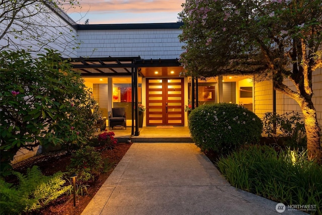 entrance to property with a pergola