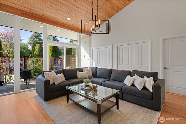 living room featuring high vaulted ceiling, a chandelier, wood ceiling, light wood-type flooring, and recessed lighting