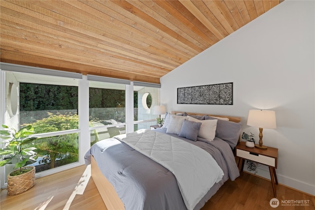 bedroom with wood ceiling, lofted ceiling, baseboards, and wood finished floors