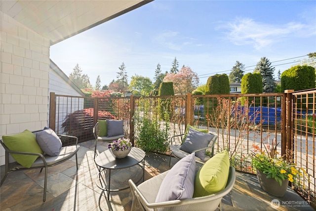 view of patio / terrace featuring an outdoor hangout area and fence
