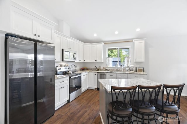 6 SE 16th St, Chehalis, WA 98532 - kitchen featuring white cabinetry, appliances with stainless steel finishes, a breakfast bar, and a sink