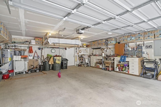 6 SE 16th St, Chehalis, WA 98532 - garage featuring a workshop area, water heater, and a garage door opener
