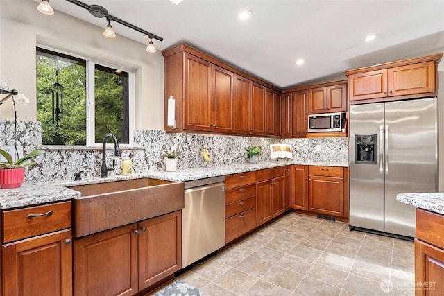 26911 312th Ave SE, Ravensdale, WA 98051 - kitchen featuring brown cabinets, tasteful backsplash, appliances with stainless steel finishes, and a sink