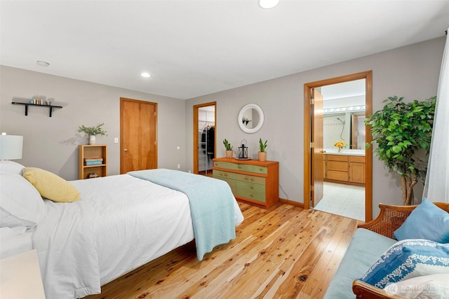 26911 312th Ave SE, Ravensdale, WA 98051 - bedroom featuring a closet, ensuite bathroom, light wood-type flooring, recessed lighting, and baseboards