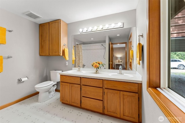 26911 312th Ave SE, Ravensdale, WA 98051 - full bathroom with toilet, visible vents, a sink, and double vanity