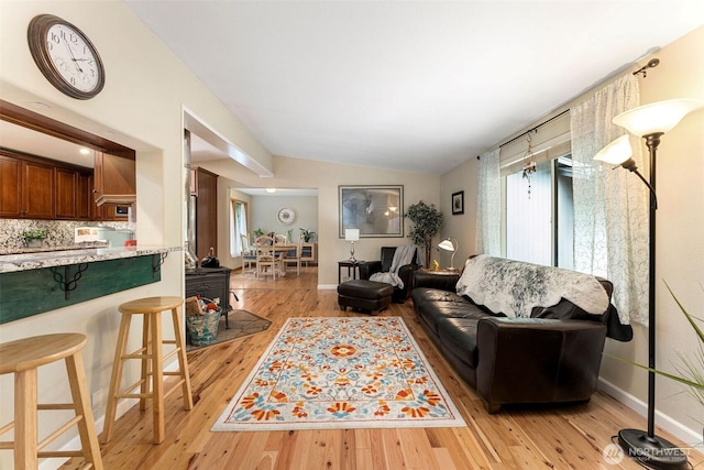 26911 312th Ave SE, Ravensdale, WA 98051 - living area with baseboards, light wood-style flooring, and vaulted ceiling