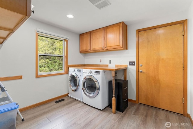 26911 312th Ave SE, Ravensdale, WA 98051 - clothes washing area with cabinet space, independent washer and dryer, light wood-type flooring, visible vents, and baseboards