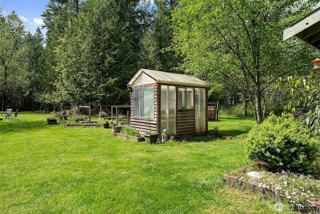 26911 312th Ave SE, Ravensdale, WA 98051 - view of yard featuring a greenhouse, a garden, and an outdoor structure