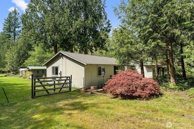 26911 312th Ave SE, Ravensdale, WA 98051 - view of side of home featuring a yard, fence, and a gate