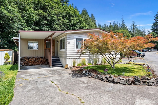 16300 State Highway 305 NE Unit 94, Poulsbo, WA 98370 - manufactured / mobile home with an attached carport, driveway, and a front lawn