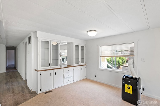 16300 State Highway 305 NE Unit 94, Poulsbo, WA 98370 - kitchen with white cabinets, glass insert cabinets, and carpet flooring