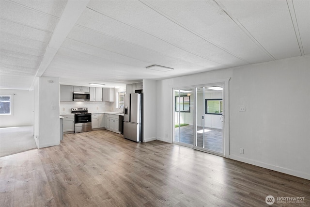 16300 State Highway 305 NE Unit 94, Poulsbo, WA 98370 - kitchen with appliances with stainless steel finishes, gray cabinetry, light wood-type flooring, and light countertops