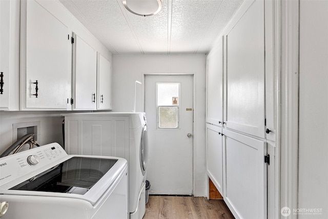 16300 State Highway 305 NE Unit 94, Poulsbo, WA 98370 - washroom featuring independent washer and dryer, cabinet space, a textured ceiling, and light wood-style floors