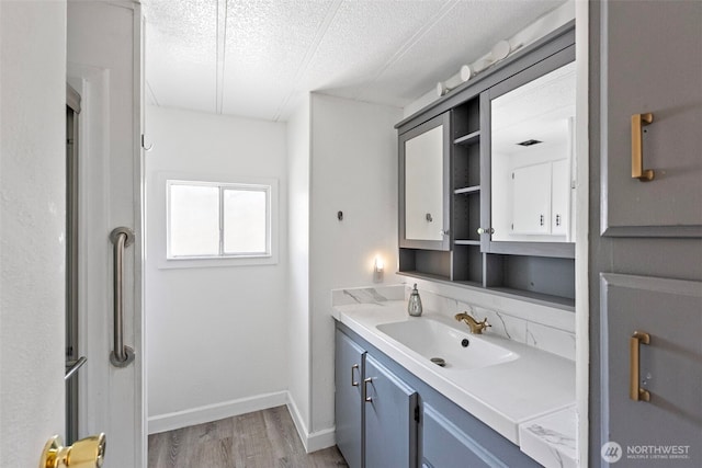 16300 State Highway 305 NE Unit 94, Poulsbo, WA 98370 - bathroom featuring vanity, wood finished floors, and a textured ceiling