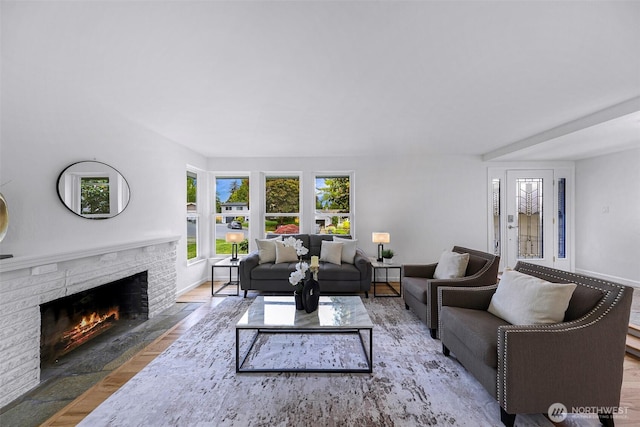 12219 SE 64th Pl, Bellevue, WA 98006 - living area featuring a brick fireplace, wood finished floors, and baseboards