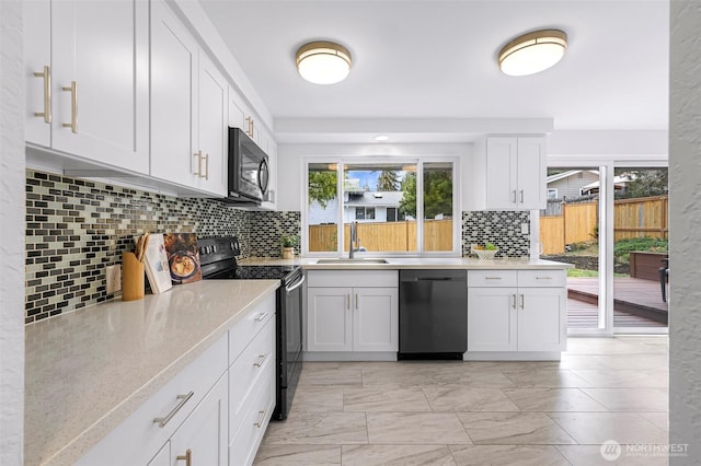 12219 SE 64th Pl, Bellevue, WA 98006 - kitchen featuring black appliances, a sink, backsplash, white cabinets, and healthy amount of natural light