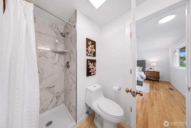 12219 SE 64th Pl, Bellevue, WA 98006 - ensuite bathroom featuring a stall shower, wood finished floors, toilet, and baseboards