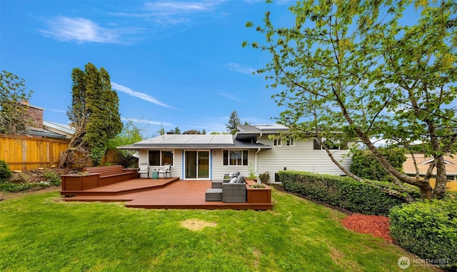 12219 SE 64th Pl, Bellevue, WA 98006 - back of house with roof mounted solar panels, a wooden deck, and an outdoor living space
