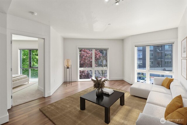 living area with wood finished floors and baseboards
