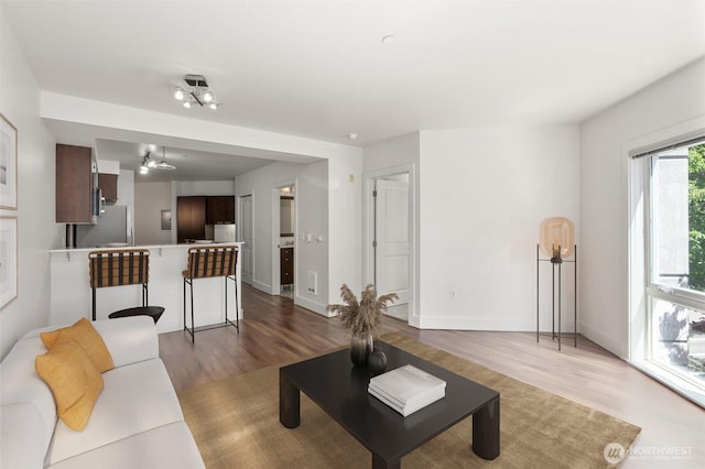 living room with wood finished floors and baseboards